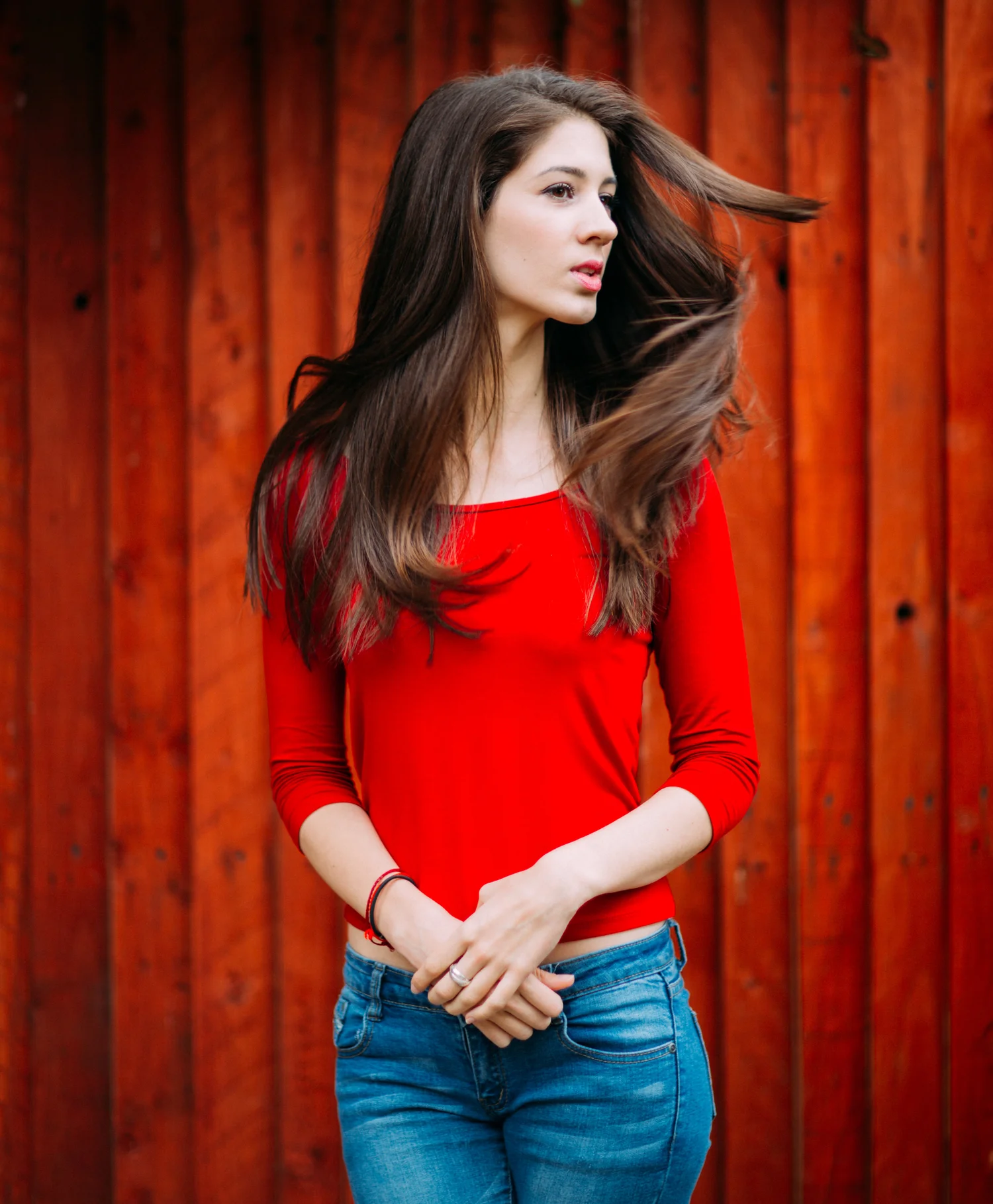 Woman red top long hair wooden wall – Portrait