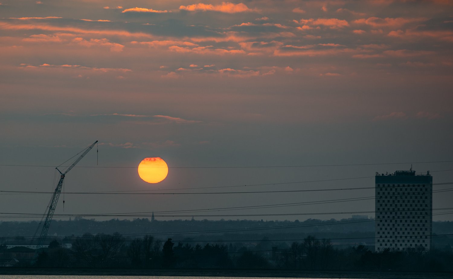 Sunset sun haze city skyline moody – Landscape