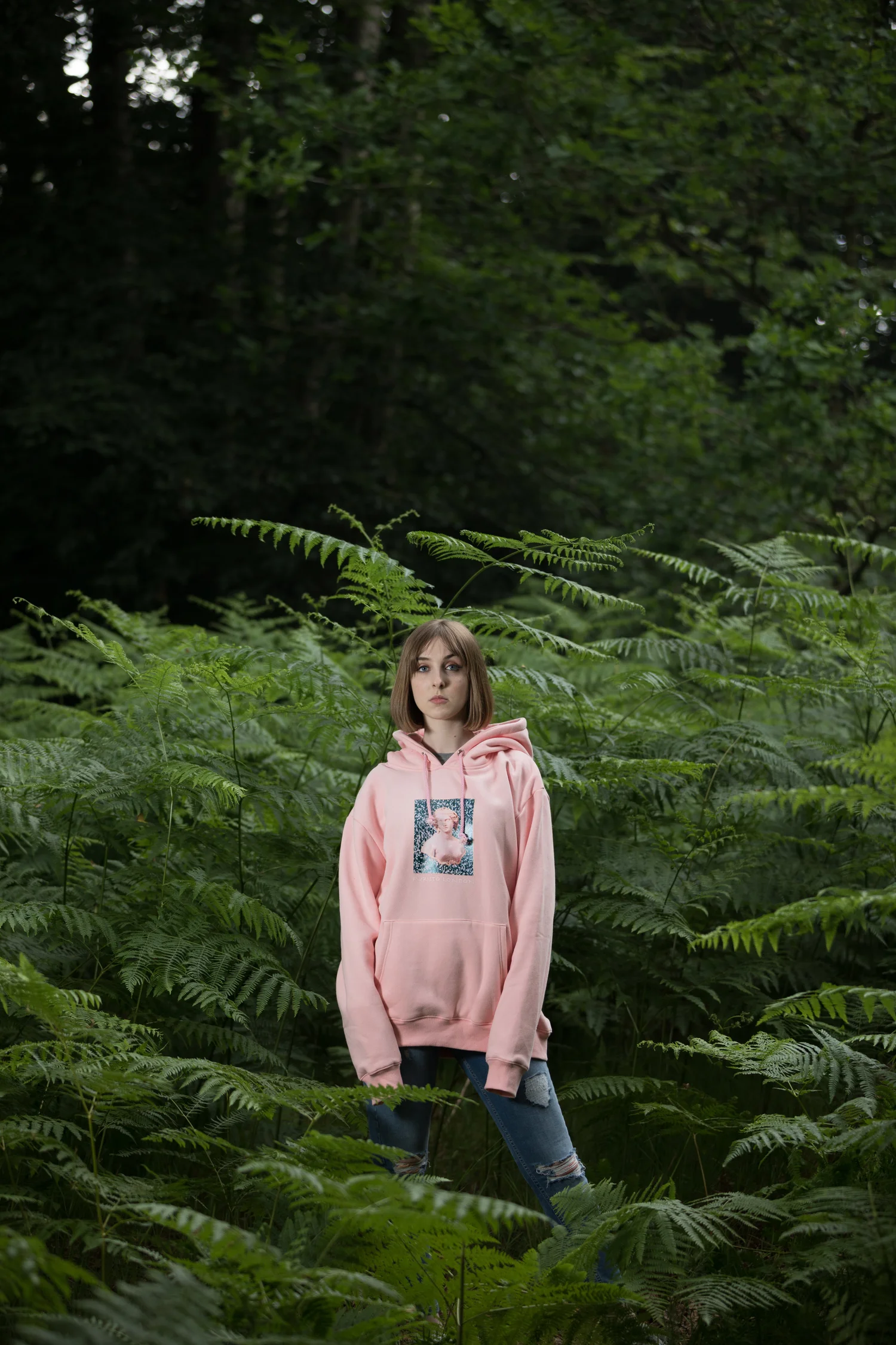 Woman forest ferns pink hoodie green woodland – Portrait