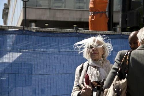 Street woman wind hair blue wall elderly – Street