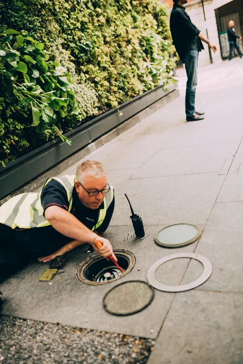 Street worker manhole hi-vis road green wall – Street