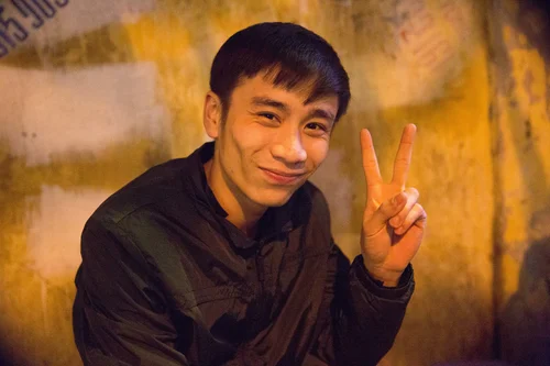 Vietnam man portrait peace sign smiling night – Vietnam