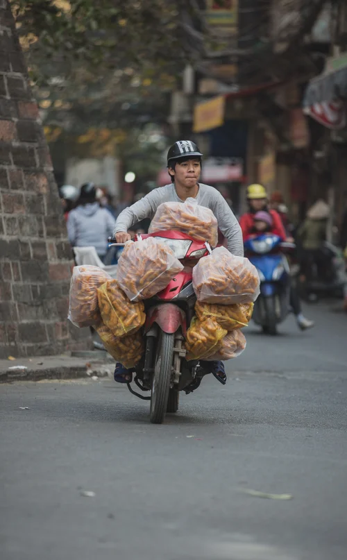 Vietnam motorbike man carrying load street hanoi – Vietnam