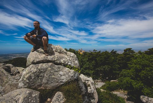 Portugal man sitting rocks viewpoint sintra sky – Portugal