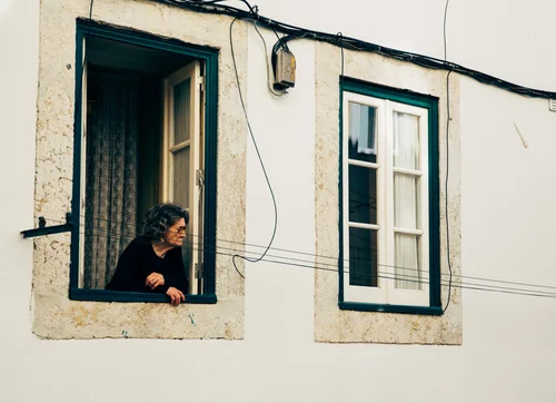 Portugal woman window white wall street candid – Portugal