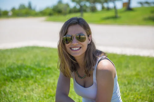Portugal woman sunglasses park grass portrait smiling – Portugal
