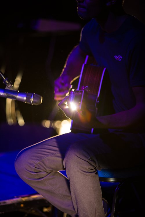 Guitarist acoustic guitar stage dark musician live – Cynical headliner show