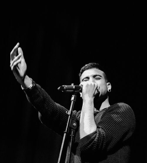 Singer man microphone hands stage concert live – Cynical headliner show