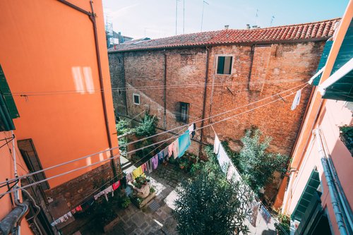 Venice courtyard laundry windows orange walls – Italy Venice