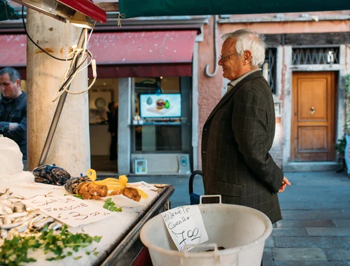 Venice market fruit vendor elderly man – Italy Venice