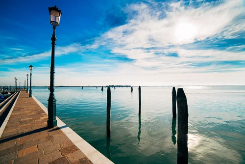 Venice lagoon sunny water lamp post pier – Italy Venice