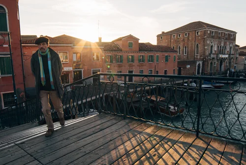 Venice man walking bridge sunset canal street – Italy Venice