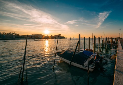 Venice sunset lagoon boats gondola poles water – Italy Venice