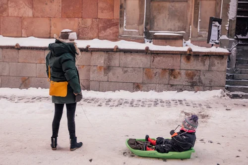 Stockholm woman pulling sledge child snow winter – Stockholm