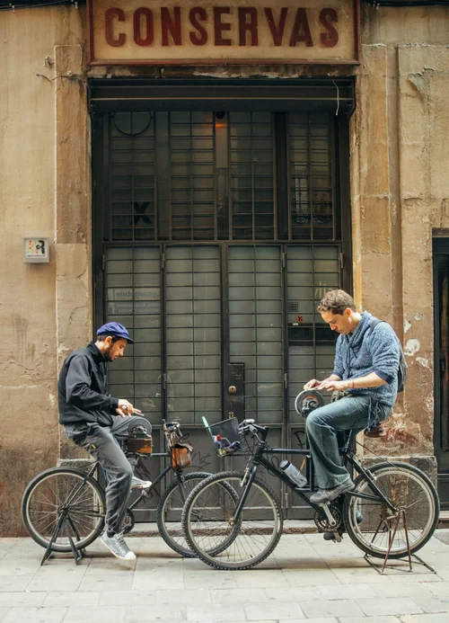 Barcelona street two men bicycles shop old – Barcelona