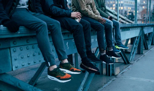 Legs feet people sitting bench trainers shoes – Street