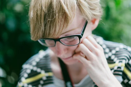 Copenhagen woman glasses laughing candid green portrait – Copenhagen