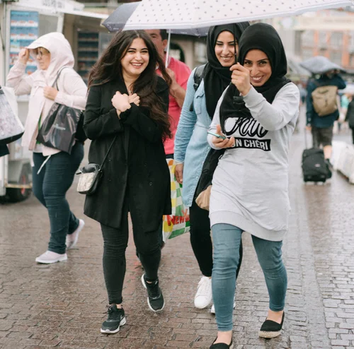 Copenhagen women friends laughing street candid hijab – Copenhagen