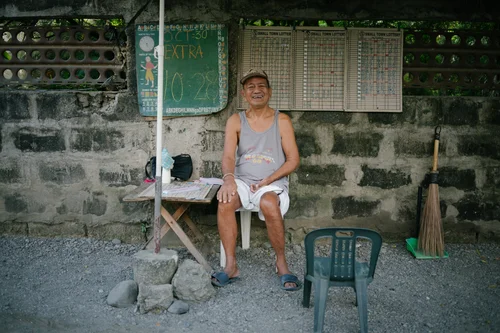 Philippines man sitting chair wall street candid – Philippines