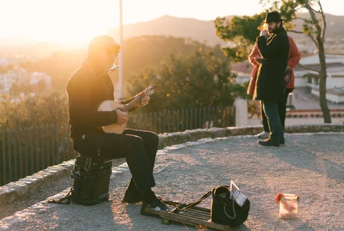 Busker street musician guitar sunset street performer – Street