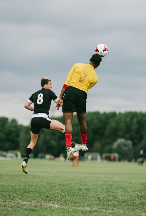 Grass roots football hackney marshes header jump – Sports & Event Photography